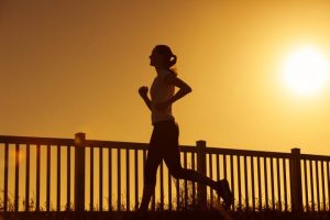 Woman running at sunset