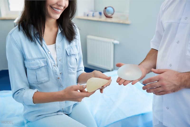 Woman discussing breast implant options with her board-certified plastic surgeon.